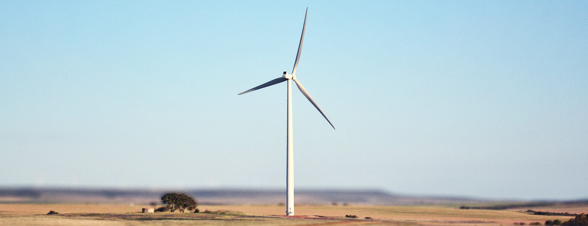 Wind turbine in Australia surrounded by bush and desert